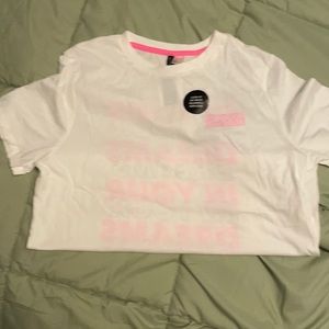 A brand new T-shirt with pink the shirt says in your dreams size medium